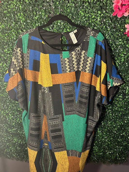 African print Colorful patterned jacket on a hanger against a green leafy background