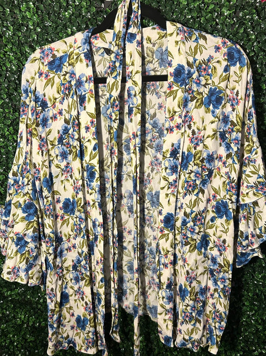 Floral-patterned robe hanging against a green leafy background